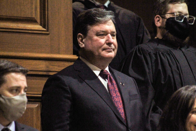 Todd Rokita is a White man with dark, graying hair. He is wearing a black suit, white shirt and red tie.